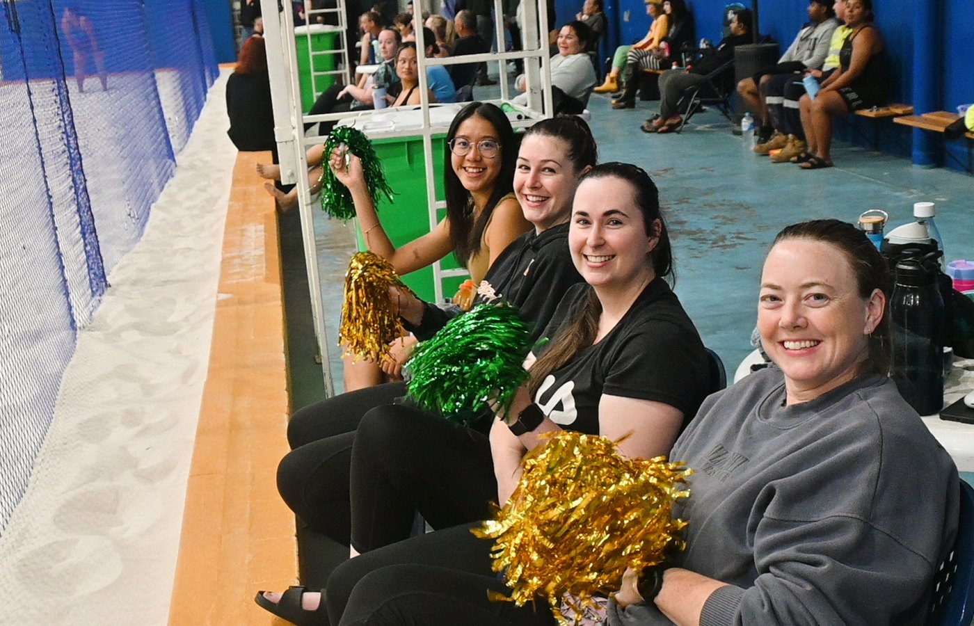 Players smiling while supporting from the sideline